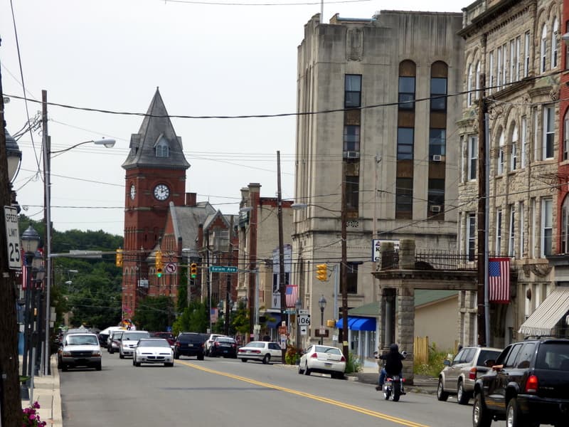 Carbondale street with brick clock tower, traffic and City Hall in the distance