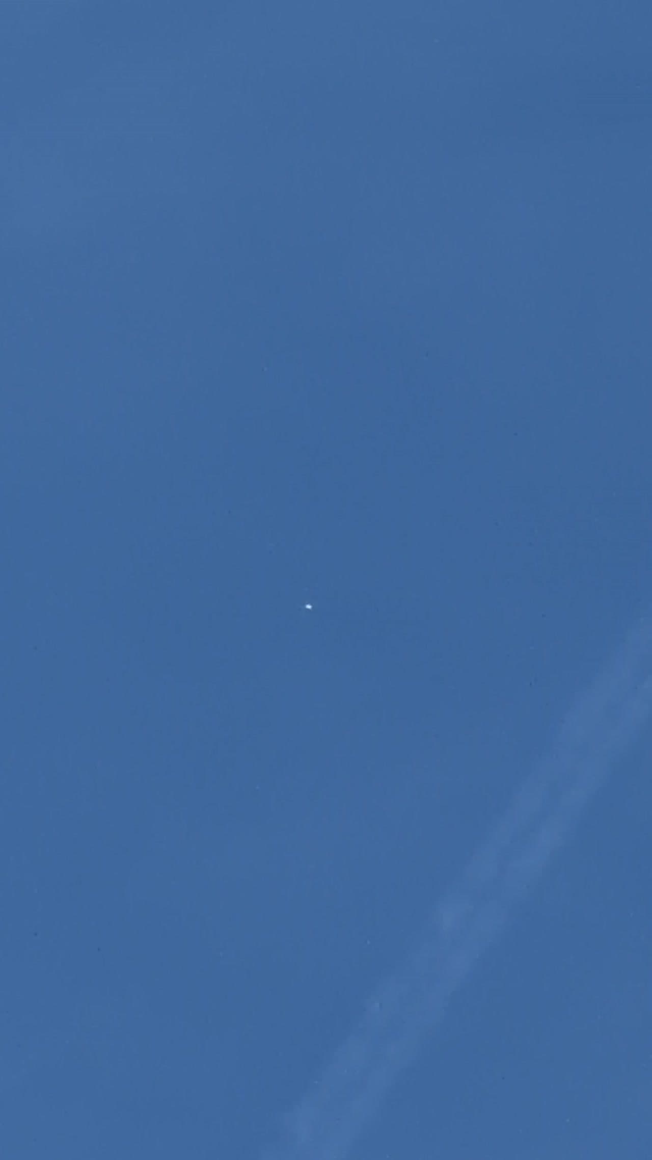 Pequeño objeto reflectante filmado sobre el norte de Londres mientras pasa un avión
